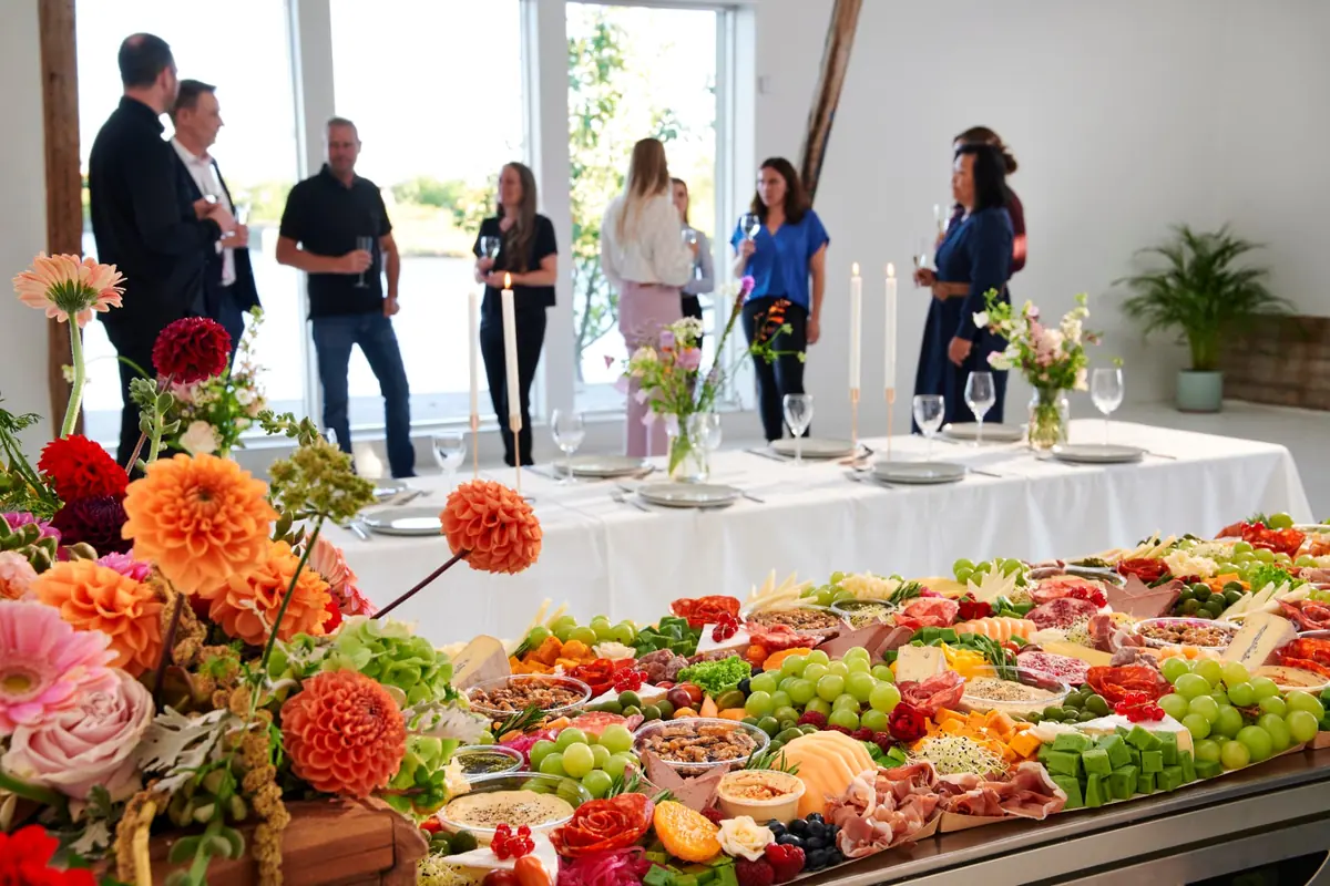 Festligt dækket bord med tapaslandskab og blomster